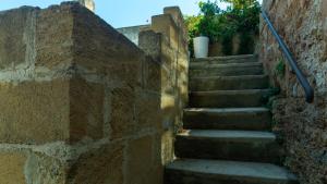 a set of stairs in a stone wall at Dimora Zenieri – Terrazze & Piscina in Casarano