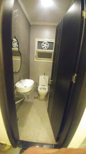 a bathroom with a toilet and a sink at Wissam in Sheikh Zayed