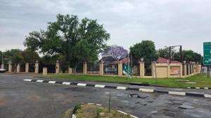 a road with a street sign next to a building at Ntale Guest House in Benoni