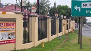 a row of fences next to a street sign at Ntale Guest House in Benoni