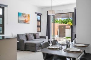 a living room with a couch and a table at Freesia Apartment 3 by Mau-Rent Houses in Trou aux Biches