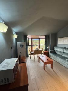 a living room with a couch and a table at Apartamento en Alpedrete in Alpedrete