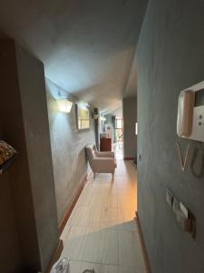 a hallway with a chair and a couch in a room at Apartamento en Alpedrete in Alpedrete