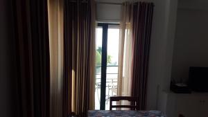 a bedroom with a window with a view of a patio at Clube Meia Praia in Lagos