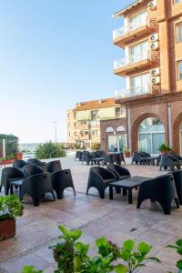 a group of tables and chairs in front of a building at Hotel Reviens in Pinamar +19 photos