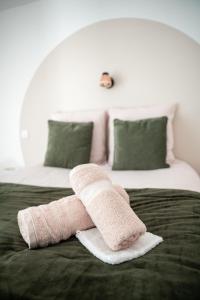 a pair of towels sitting on top of a bed at Private Spa and Garden 10 min from Mont St-Michel in Pontorson
