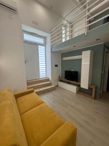 a living room with a couch and a television at AparthouseRisorgimento in Frattamaggiore