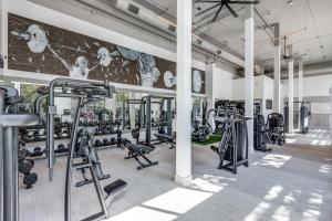 a gym with several tread machines and a mural at Centrally-Located 1BR Suite with Resort Pool View in Frisco