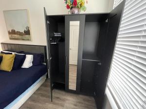 a black bedroom with a bed and a mirror at Centrally-Located 1BR Suite with Resort Pool View in Frisco