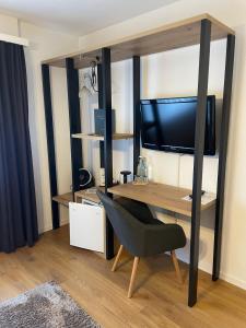 a room with a desk with a computer and a chair at Hotel Europe Brig in Brig