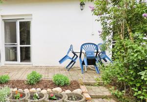a blue chair sitting next to a house at Gemütliche Ferienwohnung nähe Wutachschlucht in Hüfingen