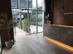 a lobby of a building with a potted plant at Nido x Nomad Pablo Neruda GDL in Guadalajara +149 photos