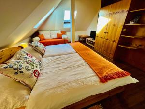 a large bed in a room with an attic at Pension am Campus Velden in Velden am Wörthersee