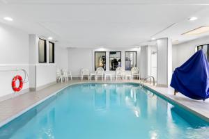 a swimming pool with blue water in a hotel room at Sleep Inn & Suites Princeton I-77 in Princeton