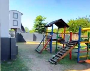 a playground with a slide and a play structure at Peaceful stay in Richards Bay