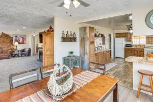 a kitchen and living room with a wooden table at On 17-Acre Lot with Barn and Patio Rural Aztec Home in Aztec