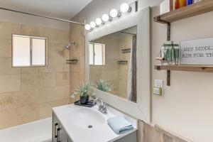 a bathroom with a sink and a tub and a mirror at On 17-Acre Lot with Barn and Patio Rural Aztec Home in Aztec +27 photos