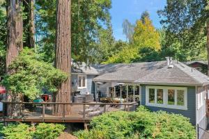 a blue house with a deck in the woods at The Sandy Star in Guerneville