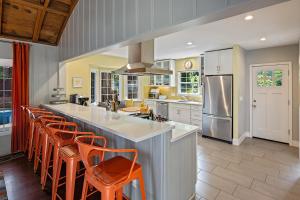 a kitchen with orange chairs and a large kitchen island at The Sandy Star in Guerneville