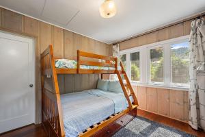 a bedroom with two bunk beds and a window at The Sandy Star in Guerneville