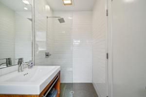 a white bathroom with a sink and a shower at The Sandy Star in Guerneville +46 photos