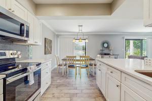 a kitchen with a table and a dining room at Seascape Golf Villas 95E in Destin