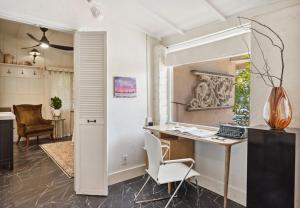 an office with a desk and a computer in a room at Adobe Cottage at Speakeasy Hotel - Adults Only in Palm Springs
