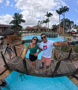 a man and a woman on a raft in the water at a resort at Hotel Casa Grande Gravatá in Gravatá