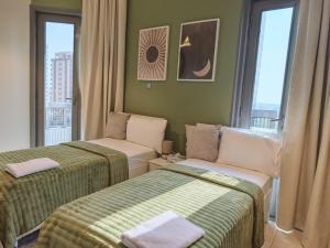 a hotel room with two beds and a window at TheGrid-Downtown HomeStay Abu Dhabi in Abu Dhabi
