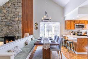a dining room with a table and a fireplace at Chetola: Chestnut 8 in Blowing Rock