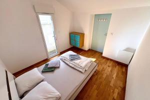 a living room with a couch and a window at Bright house with garden in Saint-Sébastien-sur-Loire