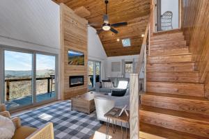 a living room with wood paneling and a staircase at Calling Me Home in Blowing Rock