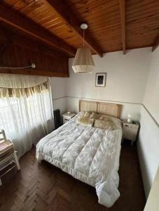 a bedroom with a bed and a wooden ceiling at Chalet House in La Plata 