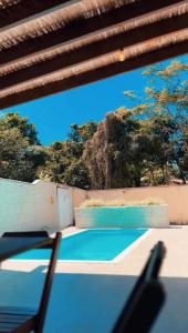 a view of a tennis court from inside a building at Residencial Recanto dos Colibris in Porto Seguro