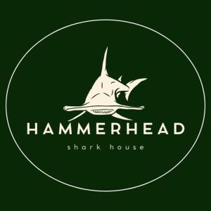 a green emblem with a hammerhead shark house at Shark House in Bellavista