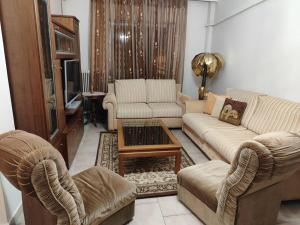 a living room with two couches and a tv at Φουντούκι in Veria