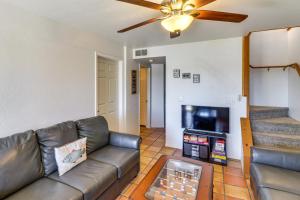 a living room with a couch and a flat screen tv at Firelit Nights By the Lake Cozy Show Low Retreat in Show Low