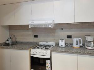 a kitchen with a stove and a counter top at Sol del Atardecer in Rada Tilly