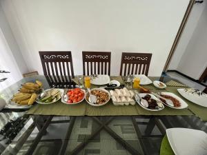 a table with plates of food on it at Serenique Greens in Peradeniya +23 photos