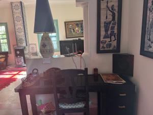 a desk with a lamp and a chair in a room at Villa Zaïtoun in Aït Ourir