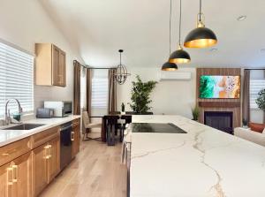 a kitchen with a large white counter top and wooden cabinets at Designer's Touch in San Diego +6 photos
