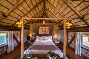 a bedroom with a large bed in a room at Parador Cambará do Sul in Cambara do Sul