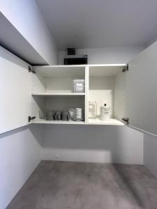 a room with white walls and white shelves at Replay F405 By S&p Villa Management in Amphoe Koh Samui