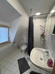 a white bathroom with a sink and a toilet at Der OXE am Maindreieck in Niederdorla +10 photos