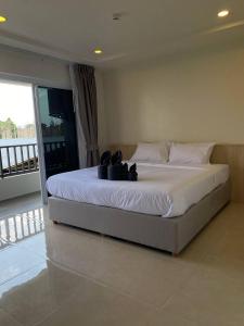 a large bed in a bedroom with a balcony at The Terraza A212 - Cozy Apartment By Sp Villa in Amphoe Koh Samui +7 photos