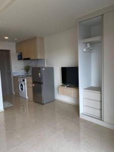 a kitchen with a stainless steel refrigerator and a tv at The Terraza A212 - Cozy Apartment By Sp Villa in Amphoe Koh Samui