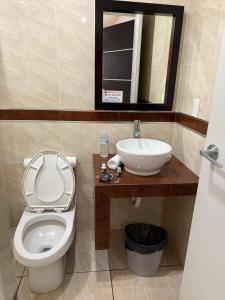a bathroom with a toilet and a sink at ZAMORA EJECUTIVO EXPRESS in Zamora de Hidalgo +13 photos