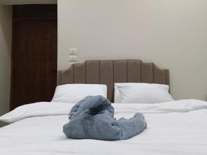 a stuffed animal is laying on a bed at Aurum Pyramids in Cairo