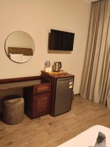 a hotel room with a sink and a mirror at Aurum Pyramids in Cairo +44 photos