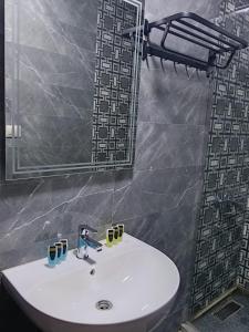 a white sink in a bathroom with a mirror at Aurum Pyramids in Cairo